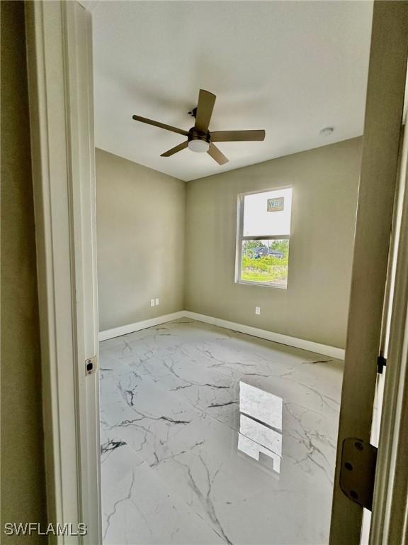 empty room featuring ceiling fan