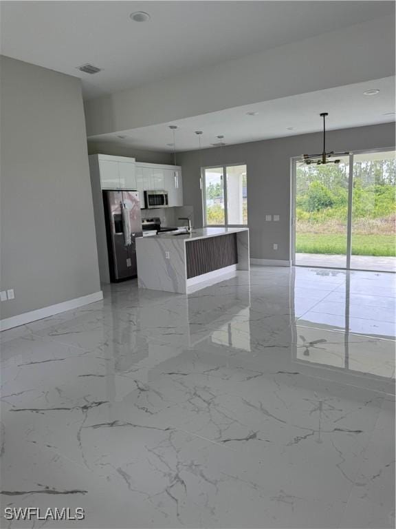 2810 27th St SW, Lehigh Acres, FL 33976 - unfurnished living room with baseboards, light marble finish floors, a sink, and recessed lighting