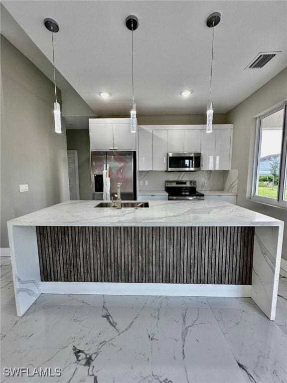 2713 26th St SW, Lehigh Acres, FL 33976 - kitchen featuring appliances with stainless steel finishes, baseboards, white cabinets, a large island, and recessed lighting