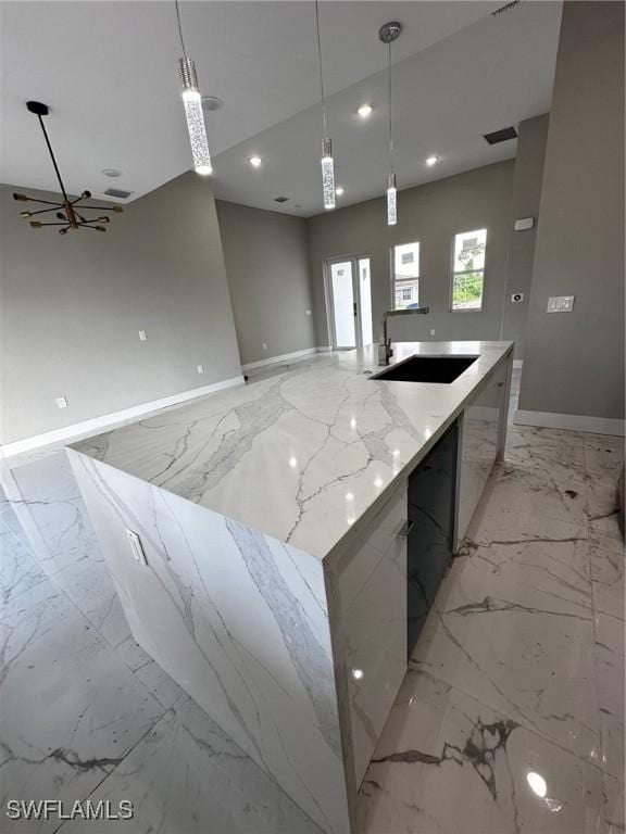 2713 26th St SW, Lehigh Acres, FL 33976 - kitchen featuring modern cabinets, a sink, light marble finish flooring, open floor plan, and recessed lighting