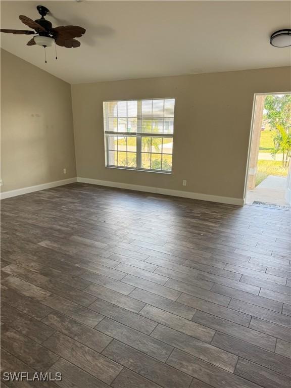 unfurnished room featuring ceiling fan, lofted ceiling, and dark hardwood / wood-style flooring