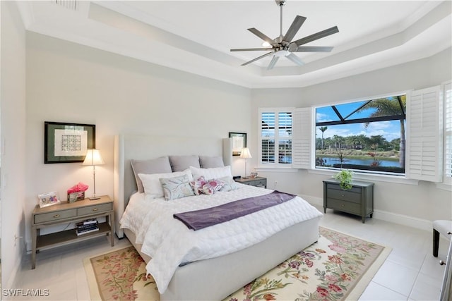 bedroom featuring baseboards, a tray ceiling, and ceiling fan