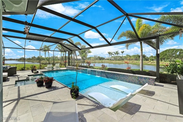 pool with glass enclosure, a water view, and a patio