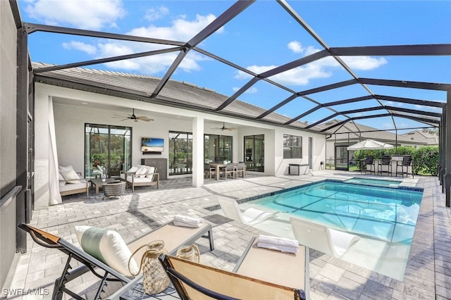 view of pool featuring an outdoor living space, a lanai, a patio area, and ceiling fan