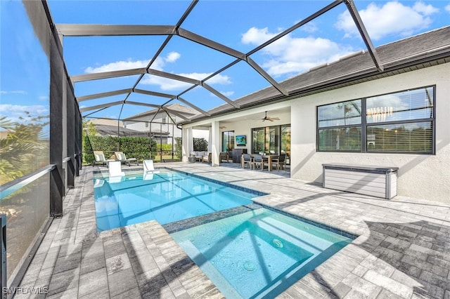 view of pool featuring a lanai, ceiling fan, and a patio area