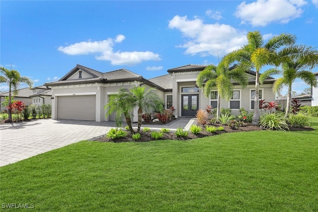 view of front of home featuring a garage, a front lawn, and french doors