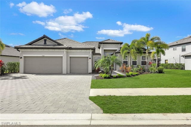 view of front of home with a garage and a front yard