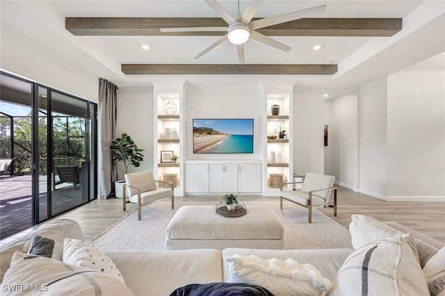 living room featuring beamed ceiling, ceiling fan, built in features, and light hardwood / wood-style floors