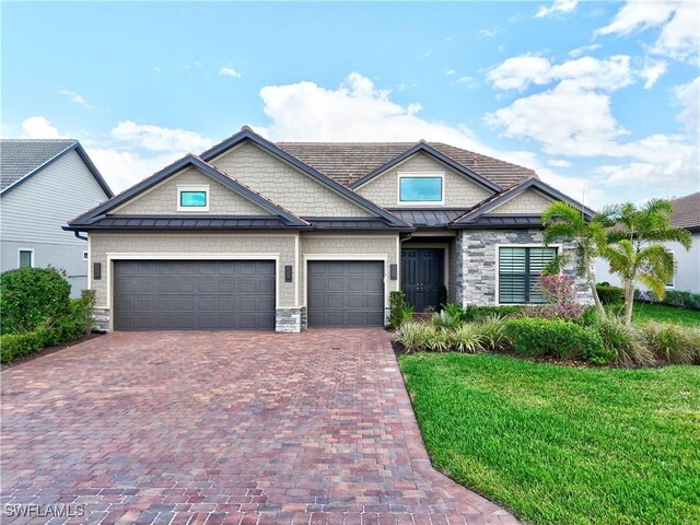 9574 Everglades Dr, Naples, FL 34120 - craftsman-style home featuring decorative driveway, an attached garage, a standing seam roof, metal roof, and a front lawn