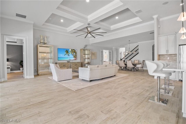 living room with light wood-type flooring, coffered ceiling, ornamental molding, and beam ceiling