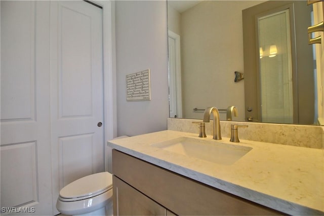 bathroom featuring toilet and vanity