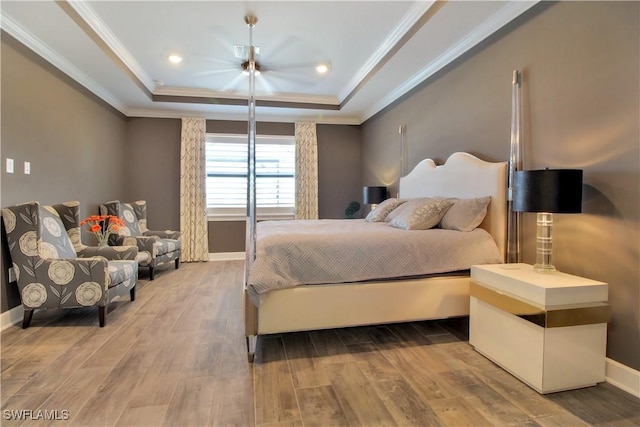 9574 Everglades Dr, Naples, FL 34120 - bedroom with baseboards, a tray ceiling, wood finished floors, and crown molding
