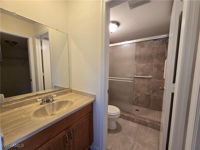 bathroom with vanity, an enclosed shower, toilet, and tile patterned floors