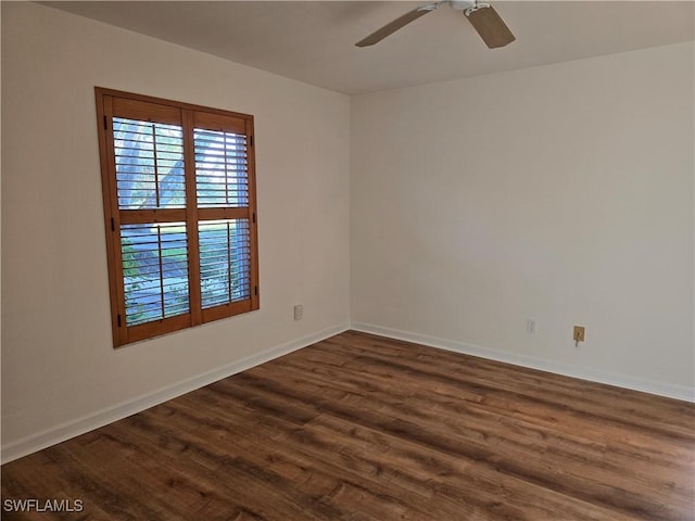 spare room with ceiling fan and dark hardwood / wood-style floors