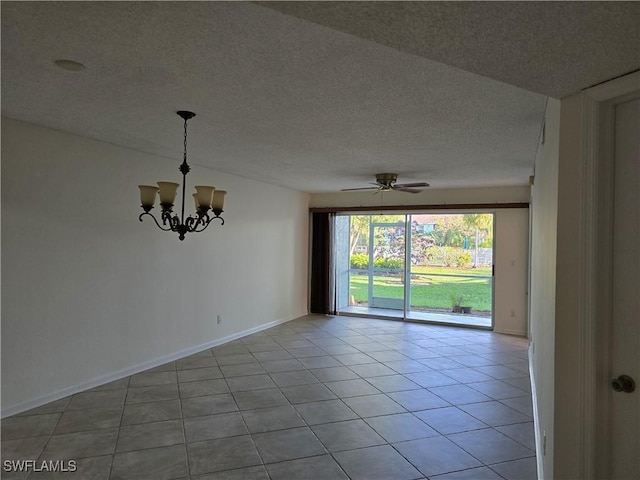 empty room featuring ceiling fan with notable chandelier, light tile patterned floors, and a textured ceiling