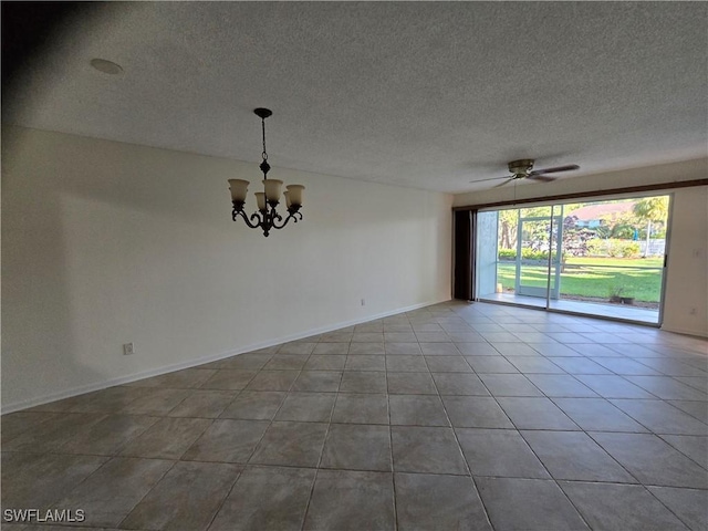 tiled empty room with a textured ceiling and ceiling fan with notable chandelier