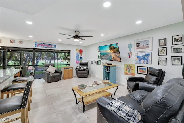 living area with ceiling fan, baseboards, and recessed lighting