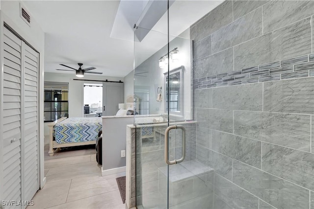 ensuite bathroom featuring visible vents, a closet, tile patterned floors, a stall shower, and ensuite bath