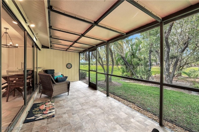 unfurnished sunroom with an inviting chandelier