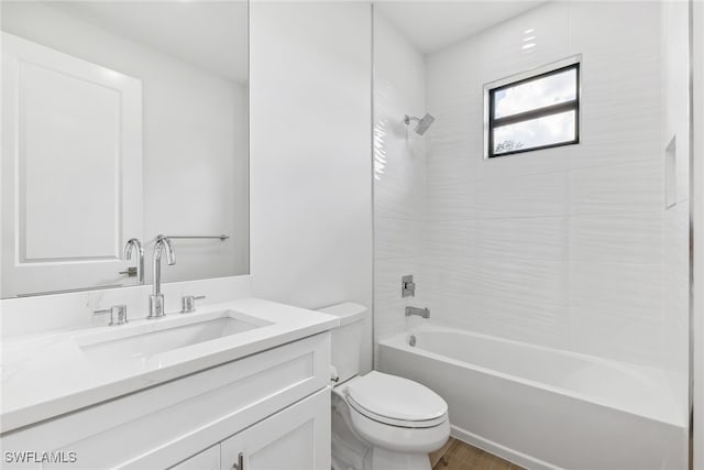 bathroom featuring shower / tub combination, vanity, toilet, and wood finished floors