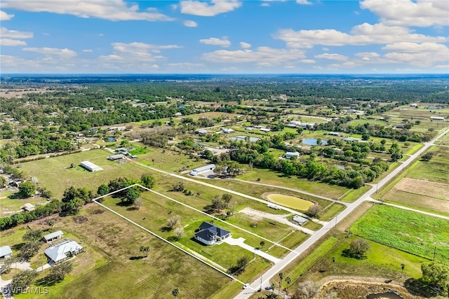 birds eye view of property with a rural view