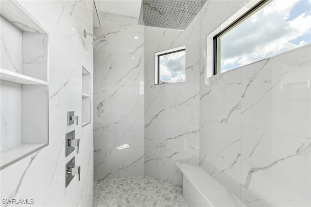 bathroom featuring a marble finish shower