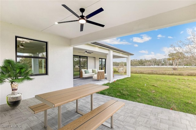 view of patio with ceiling fan and an outdoor living space