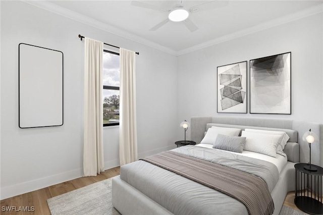 bedroom featuring ornamental molding, a ceiling fan, light wood-style flooring, and baseboards