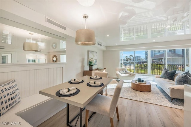 dining space featuring visible vents and wood finished floors