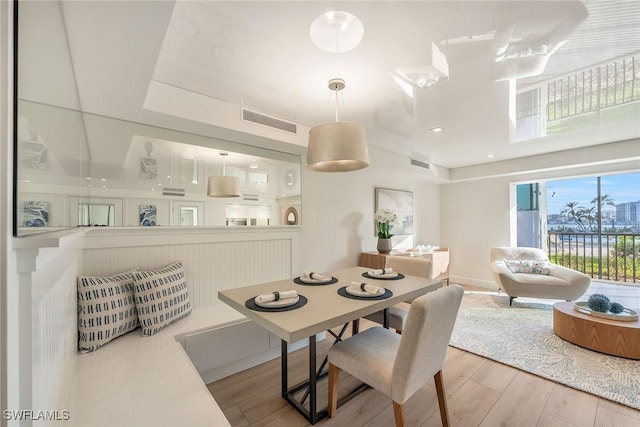 dining area with visible vents and wood finished floors