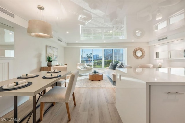 dining area with visible vents and light wood finished floors