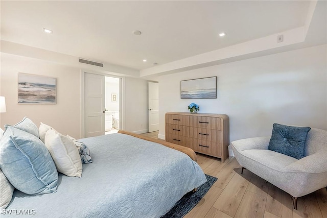 bedroom with baseboards, recessed lighting, visible vents, and light wood-style floors