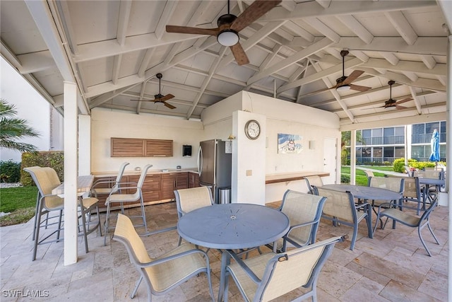 view of patio with outdoor dining space and ceiling fan