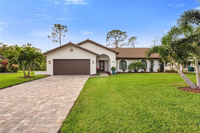 5548 Foxhunt Way, Naples, FL 34104 - mediterranean / spanish-style home with decorative driveway, a garage, stucco siding, and a front lawn