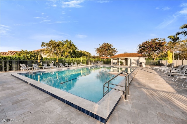 5548 Foxhunt Way, Naples, FL 34104 - community pool with a patio and an outbuilding