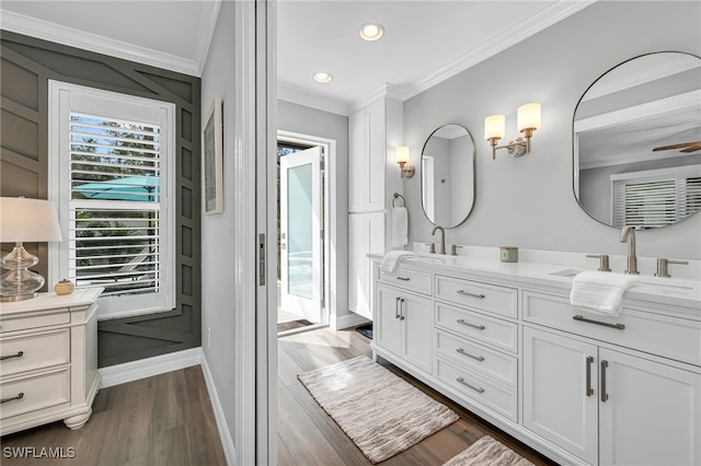 5548 Foxhunt Way, Naples, FL 34104 - full bathroom with crown molding, double vanity, wood finished floors, baseboards, and recessed lighting