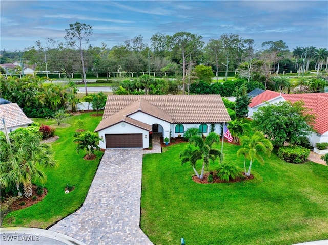 5548 Foxhunt Way, Naples, FL 34104 - view of front of property featuring a garage, a tile roof, a front yard, decorative driveway, and view of wooded area