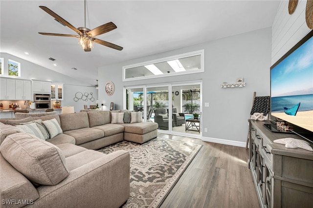 5548 Foxhunt Way, Naples, FL 34104 - living room with healthy amount of natural light, light wood finished floors, ceiling fan, high vaulted ceiling, and baseboards