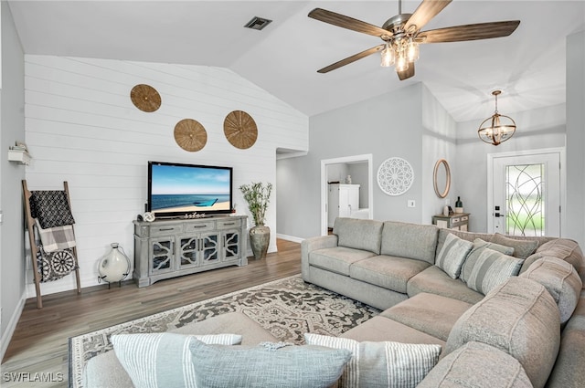 5548 Foxhunt Way, Naples, FL 34104 - living room with wood finished floors, baseboards, ceiling fan, high vaulted ceiling, and a chandelier