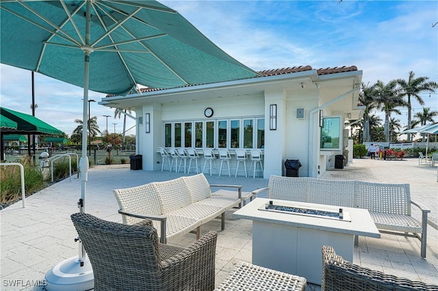 5548 Foxhunt Way, Naples, FL 34104 - view of patio featuring an outdoor living space with a fire pit