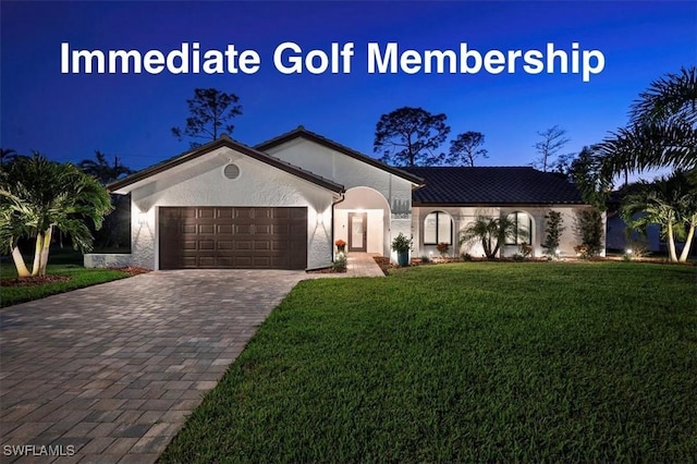 5548 Foxhunt Way, Naples, FL 34104 - view of front of house featuring a garage, a front yard, stucco siding, and driveway