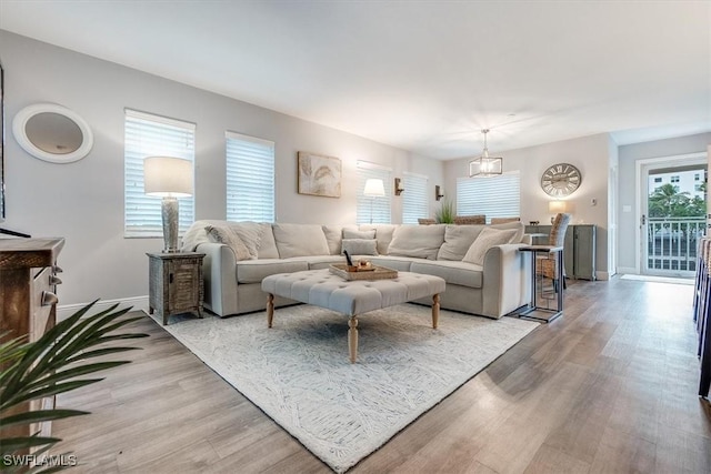 living area with light wood-style floors and baseboards