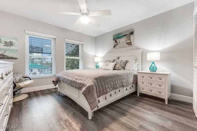 bedroom with dark wood-type flooring, baseboards, and a ceiling fan