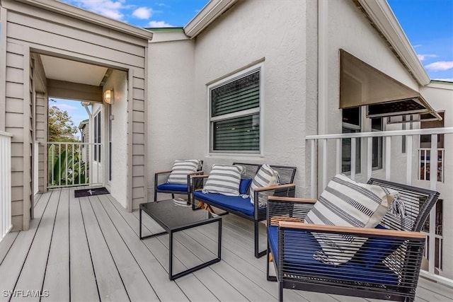 wooden terrace featuring an outdoor hangout area