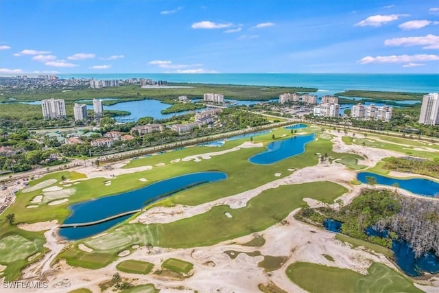 drone / aerial view with view of golf course, a water view, and a city view