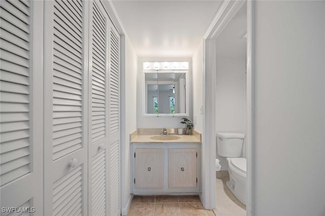 bathroom with vanity, tile patterned floors, and toilet