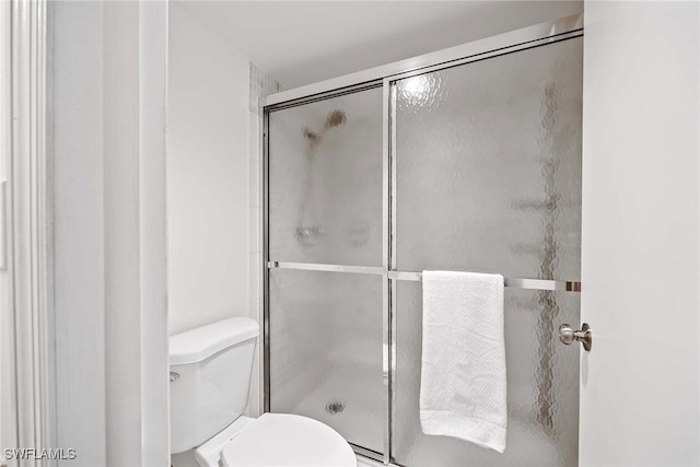 bathroom with toilet and walk in shower