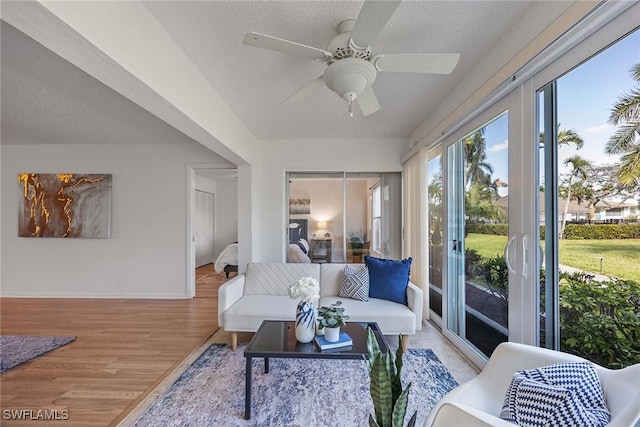 interior space with ceiling fan, light hardwood / wood-style flooring, and a textured ceiling