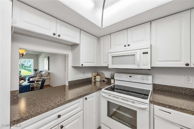 kitchen with white appliances and white cabinets