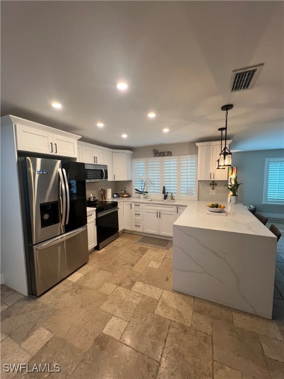 3680 Woodstork Ct, Fort Myers, FL 33908 - kitchen with visible vents, a sink, stone tile flooring, recessed lighting, and stainless steel appliances